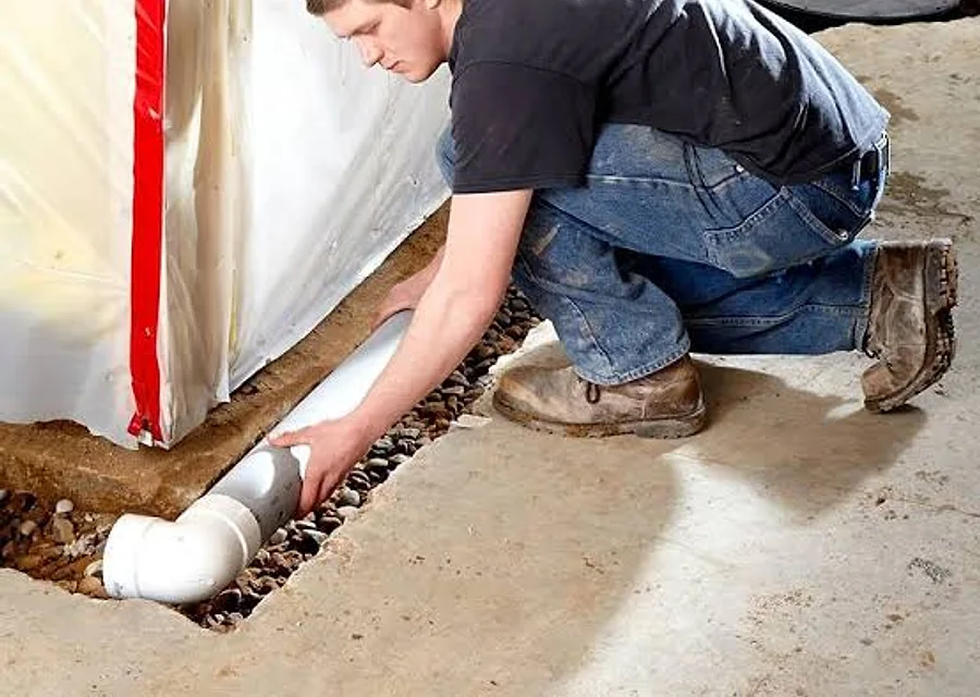 A basement wall and floor prepared for drainage and moisture control